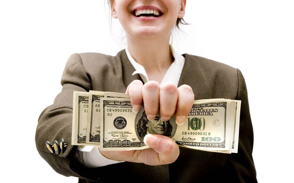 Businesswoman holding hundred dollar bills